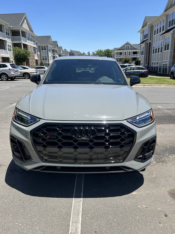 Mobile car detailing in Wesley Chapel, NC: Head-on view of a gray Audi SQ5 with clear headlights and a gloss black grille