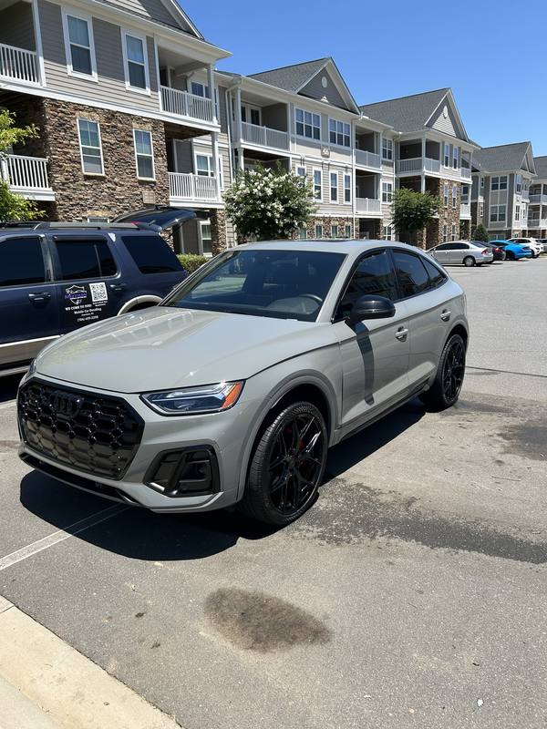 Mobile car detailing in Charlotte, NC: Gray Audi SQ5 Sportback next to the Motion Mobile Detailing van in an apartment parking lot