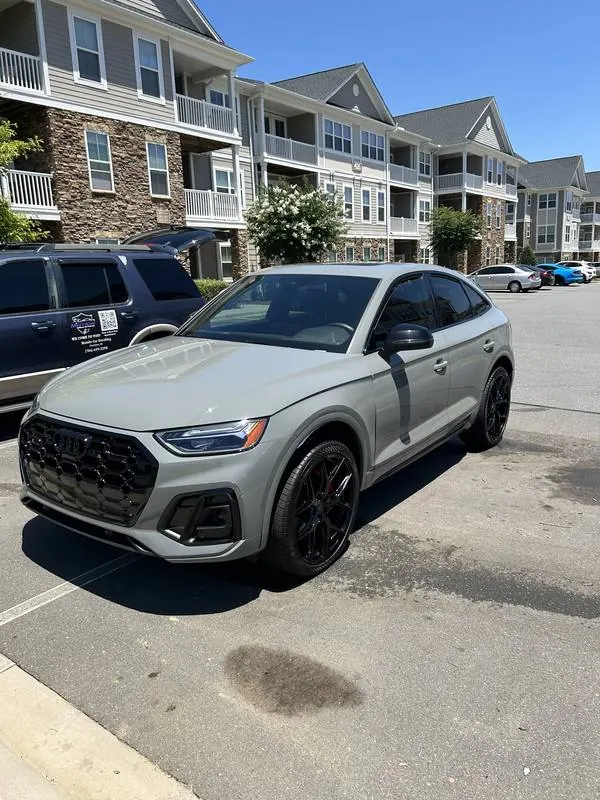 Premium mobile car detailing in Raleigh, NC: Gray Audi SQ5 Sportback next to the Motion Mobile Detailing van in an apartment parking lot