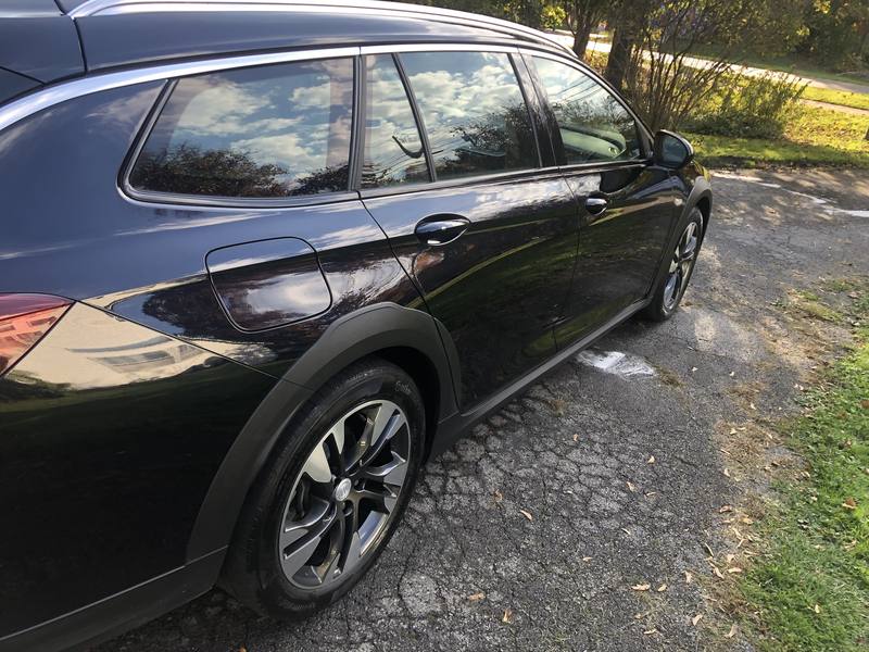 Car window tint in Charlotte, NC: Black Buick Regal TourX wagon with dark tinted side and rear windows
