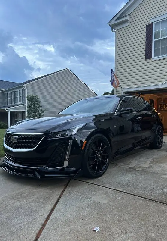 Black Cadillac CT5 with deep, glossy paint parked in a driveway