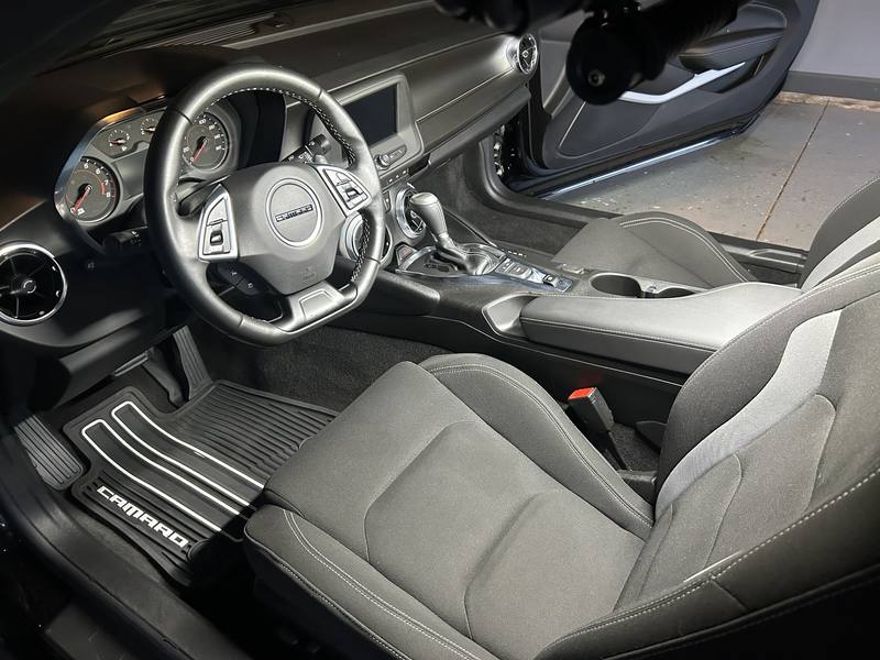 Mobile car detailing in Monroe, NC: Chevy Camaro driver seat, steering wheel, and dash after an interior detail