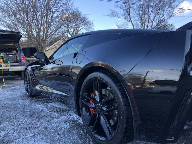 Mobile car detailing in Mint Hill, NC: Black C7 Corvette Stingray with glossy paint reflecting the sky after a detail