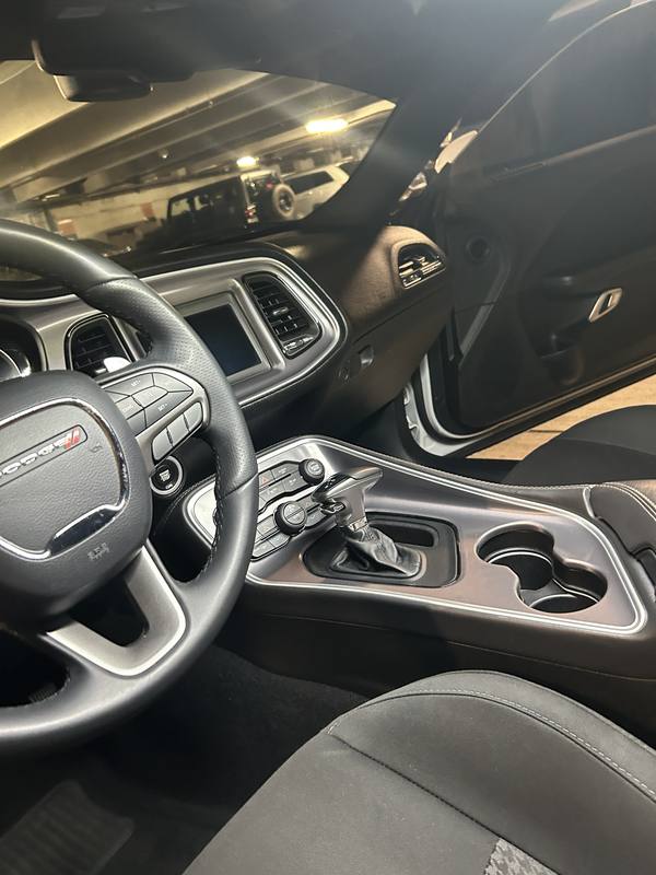Mobile car detailing in Monroe, NC: Dodge Challenger dashboard, steering wheel, and center console after an interior detail