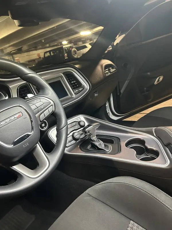 Mobile car smoke odor removal in Charlotte, NC: Dodge Challenger dashboard, steering wheel, and center console after an interior detail
