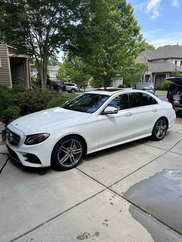 Mobile car detailing in Charlotte, NC: White Mercedes-Benz E-Class sedan in a driveway after a mobile detail