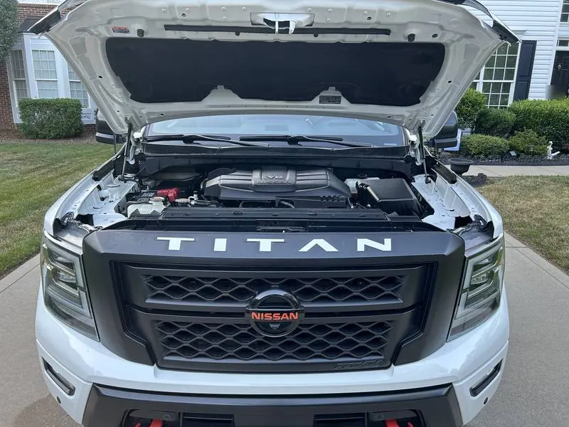 Premium mobile car detailing in Raleigh, NC: Nissan Titan PRO-4X with the hood open, showing a clean engine bay