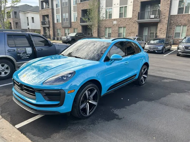 Premium mobile car detailing in Raleigh, NC: Bright blue Porsche Macan with glossy paint next to the Motion Mobile Detailing van