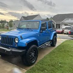 Premium mobile car detailing in Raleigh, NC: Blue Jeep Wrangler with glossy paint after a wash and wax