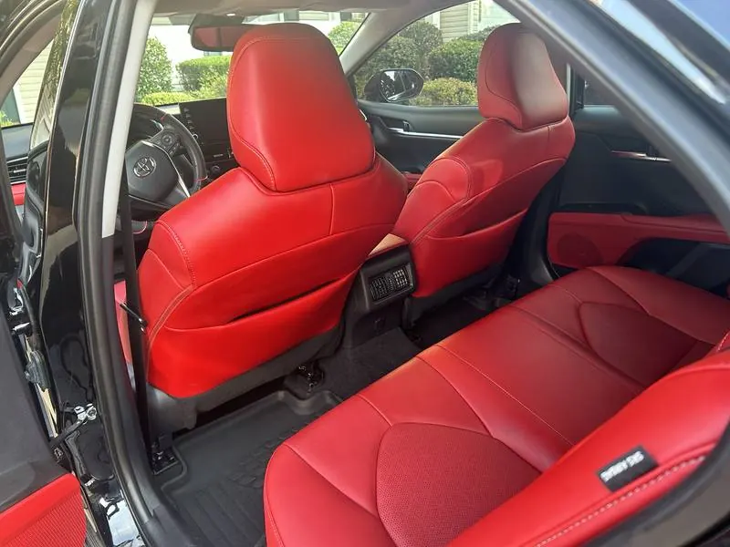 Mobile car detailing in Tega Cay, SC: Toyota Camry red leather back seats and rear floor mats after an interior detail