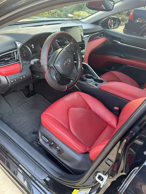 Premium mobile car detailing in Raleigh, NC: Toyota Camry red leather driver seat and dashboard after an interior detail